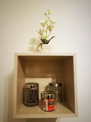 a shelf with two cans and a potted plant on it at Minohouse Vatican view in Rome