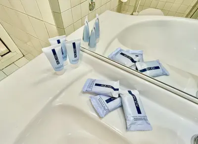 a bathroom with a sink and a tub with toothpaste at ETERNA Trastevere Apartment in Rome