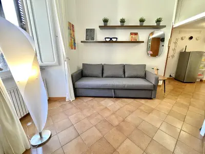 a living room with a couch and a mirror at ETERNA Trastevere Apartment in Rome