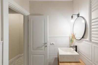 a white bathroom with a mirror and a sink at iFlat Lovely Flat in Trastevere in Rome