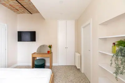 a bedroom with a bed and a desk and a tv at iFlat Lovely Flat in Trastevere in Rome