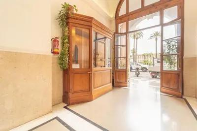 an empty lobby with a wooden door and windows at Casa Benso - near Vatican City and Navona Square in Rome