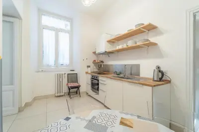 a white kitchen with a sink and a counter at Casa Benso - near Vatican City and Navona Square in Rome