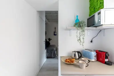 a kitchen with white walls and a red appliance on a counter at iFlat The G Flat in Rome