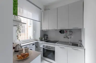 a kitchen with white cabinets and a bowl of bread at iFlat The G Flat in Rome