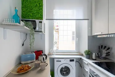 a kitchen with a washing machine and a window at iFlat The G Flat in Rome