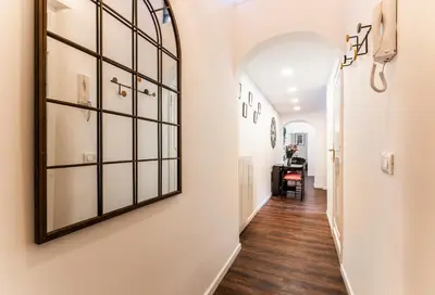 a hallway with a large mirror on the wall at Piacentino Homes Corso apartment in Rome