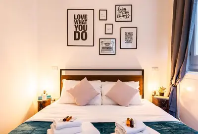 a bedroom with a bed with towels on it at Piacentino Homes Corso apartment in Rome