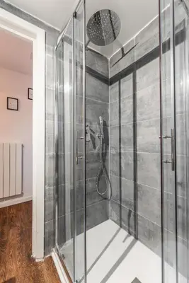 a shower with a glass door in a bathroom at Piacentino Homes Corso apartment in Rome