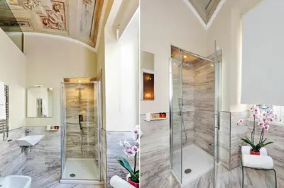 a bathroom with a shower with a glass door at AMM Luxury Rooms in Rome