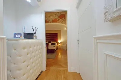 a hallway with white walls and a room with a table at AMM Luxury Rooms in Rome