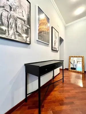 a black piano in a room with pictures on the wall at Inn Sistina Home in Rome