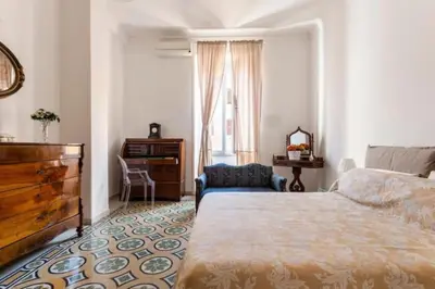 a bedroom with a bed and a dresser and a window at Holiday Apartment Rome LR Blue in Rome