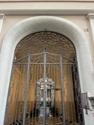 an entrance to a building with a gate with a tree on it at Holiday Apartment Rome LR Blue in Rome