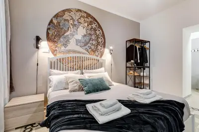 a bedroom with a large bed with towels on it at The Great Beauty - 2 double bedrooms & 2 bathrooms in Rome