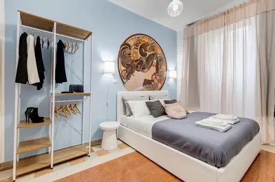 a bedroom with a bed and a closet at The Great Beauty - 2 double bedrooms & 2 bathrooms in Rome