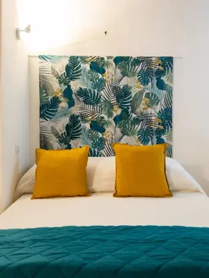 a bedroom with a bed with two yellow pillows at Lovely Nest by the Pantheon in Rome