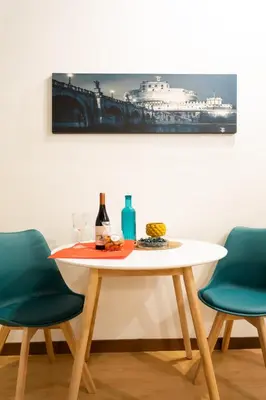 a table with two chairs and a bottle of wine at Lovely Nest by the Pantheon in Rome