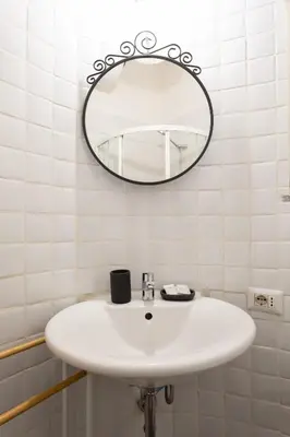 a bathroom with a white sink and a mirror at Lovely Nest by the Pantheon in Rome