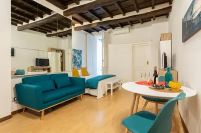 a living room with blue chairs and a table at Lovely Nest by the Pantheon in Rome