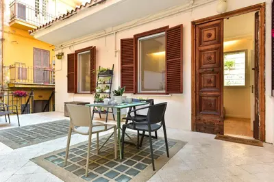 a patio with a table and chairs and a building at Paolina Boutique Apartment Monti in Rome
