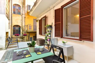 a balcony with a table and chairs and a window at Paolina Boutique Apartment Monti in Rome
