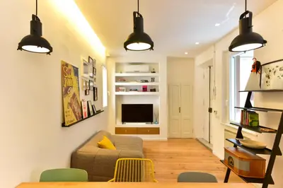 a living room with a couch and a television at Paolina Boutique Apartment Monti in Rome