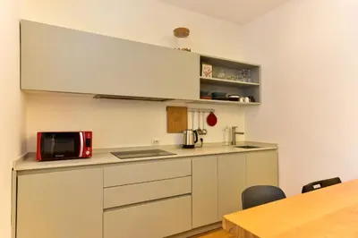 a kitchen with a red microwave and a counter at Paolina Boutique Apartment Monti in Rome