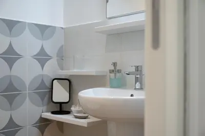 a bathroom with a sink and a mirror at Mater Rooms & Suites in Rome
