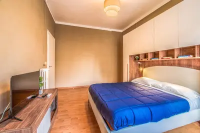 a bedroom with a blue bed and a desk at Giuliana St.Peter Apartment in Rome