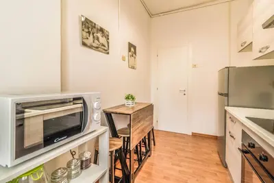 a kitchen with a microwave and a table with chairs at Giuliana St.Peter Apartment in Rome