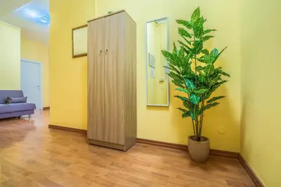 a living room with a plant and a cabinet at Giuliana St.Peter Apartment in Rome