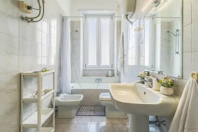 a bathroom with a sink and a toilet and a tub at Giuliana St.Peter Apartment in Rome