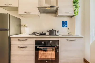 a kitchen with a stove and a sink at Giuliana St.Peter Apartment in Rome