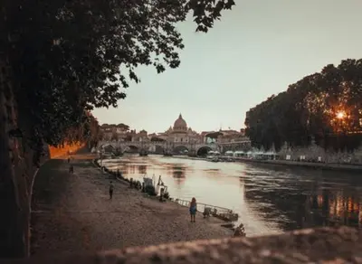 a view of a river with people walking on the beach at Fontanella Dream apartment in Rome