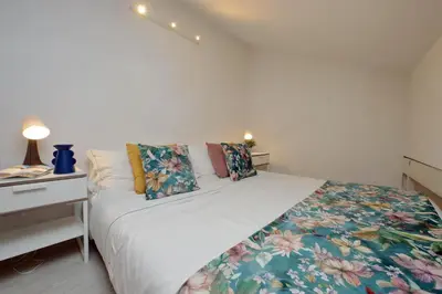 a bedroom with a bed and a nightstand with a bed sidx sidx at Fontanella Dream apartment in Rome