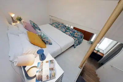 a bedroom with a bed with pillows and a table at Fontanella Dream apartment in Rome