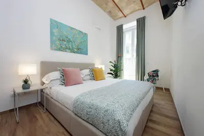 a bedroom with a large bed and a window at Principe Umberto Apartment in Rome