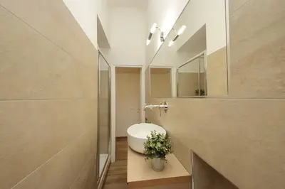a bathroom with a sink and a mirror at Principe Umberto Apartment in Rome