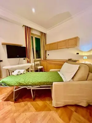 a bedroom with a large bed and a couch at Auditorium Maxxi luxury suite Roma in Rome