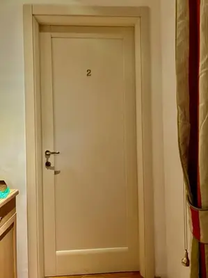 a white door in a room with a kitchen at Auditorium Maxxi luxury suite Roma in Rome