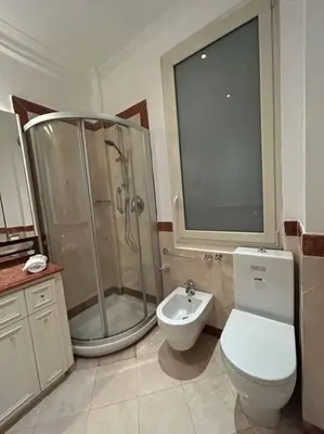 a bathroom with a shower and a toilet and a sink at Auditorium Maxxi luxury suite Roma in Rome