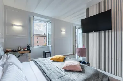 a bedroom with a bed with two pillows on it at Rome Plaza Suites, Luxury Collection in Rome