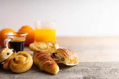 a group of croissants and oranges and a glass of orange juice at Rome Plaza Suites, Luxury Collection in Rome