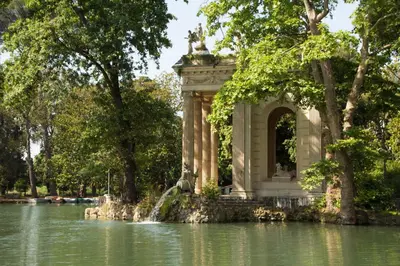 a monument in the middle of a pond in a park at Rome Plaza Suites, Luxury Collection in Rome