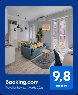 a living room with a blue couch and a kitchen at Re di Roma Apartment in Rome