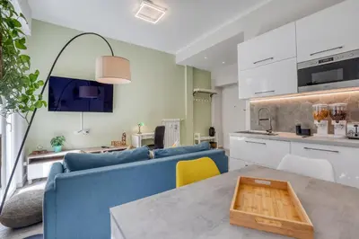 a living room with a blue couch and a table at Re di Roma Apartment in Rome