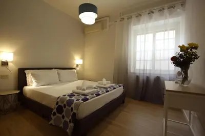 a bedroom with a bed and a window at Vascello Holiday House in Rome