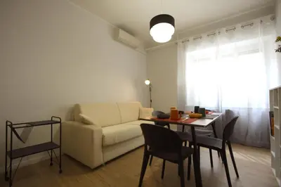 a living room with a couch and a table at Vascello Holiday House in Rome