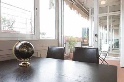 a table with chairs and a globe on top of it at Colosseo Terrace Apartment in Rome